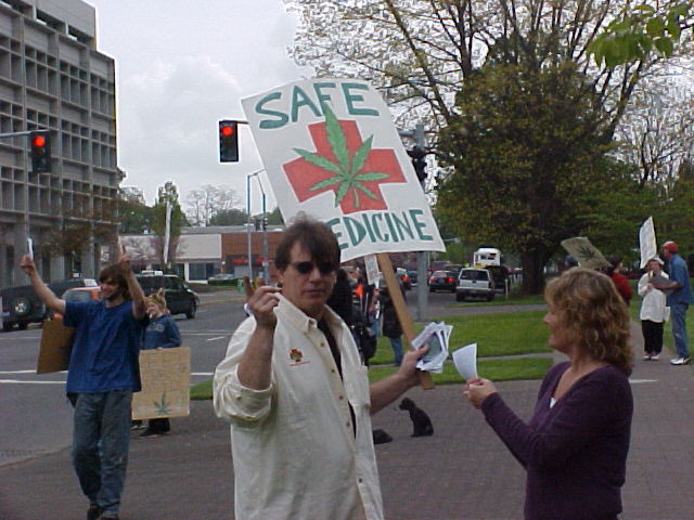 Marchers hand out flyers to passer-bys, recruiting more marchers and demonstrating to folks driving by.